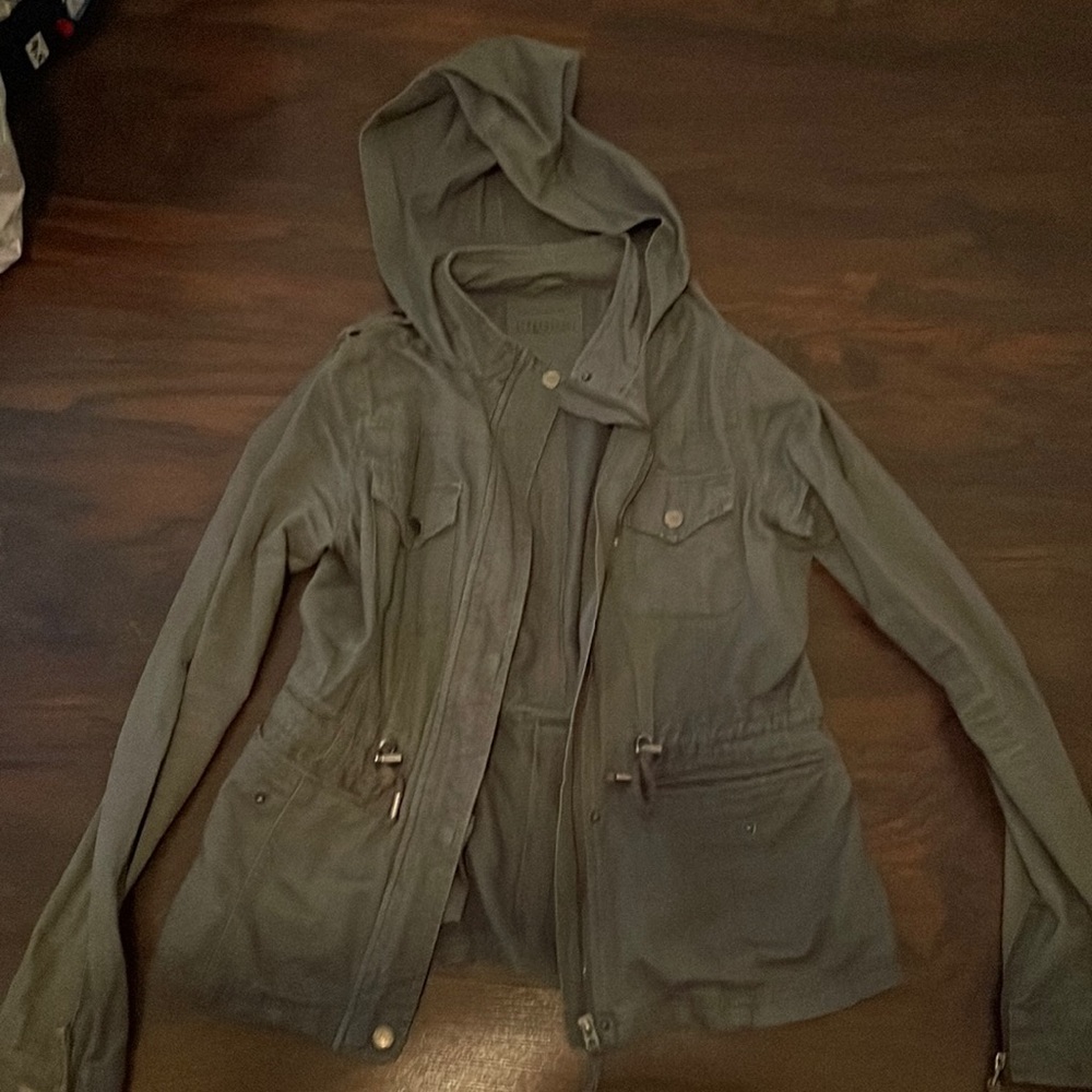 Small Green Jacket With Working Zipper and buttons, also has pockets